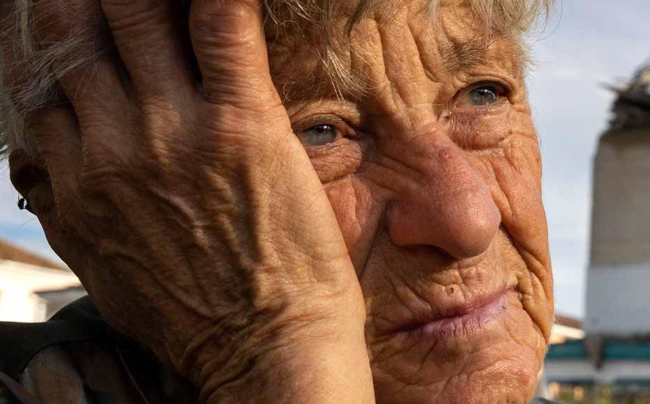 Galina Ivanenko, 77, sits in the central square on September 20, 2022 in Izium, Ukraine. She never left the city because she was taking care of handicapped family members. Izium was occupied by Russians since April 1st causing major destruction and death to the small city.