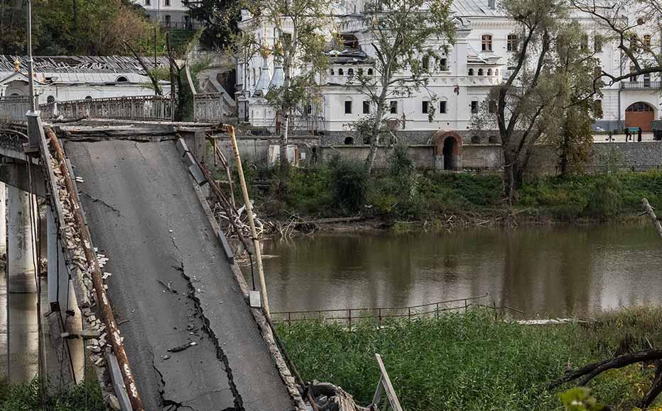 A bridge crossing the Siverskyi Donets River to Sviatohirsk Cave Monastery lies destroyed after being attacked during fighting between Russian and Ukrainian forces in the Donetsk region on October 9, 2022 in Sviatohirs'k, Donetsk, Ukraine. A bridge crossing the Siverskyi Donets River to Sviatohirsk Cave Monastery lies destroyed after being attacked during fighting between Russian and Ukrainian forces in the Donetsk region on October 9, 2022 in Sviatohirs'k, Donetsk, Ukraine.
