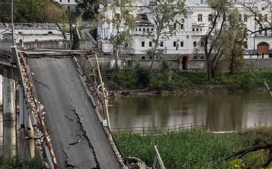 A bridge crossing the Siverskyi Donets River to Sviatohirsk Cave Monastery lies destroyed after being attacked during fighting between Russian and Ukrainian forces in the Donetsk region on October 9, 2022 in Sviatohirs'k, Donetsk, Ukraine.