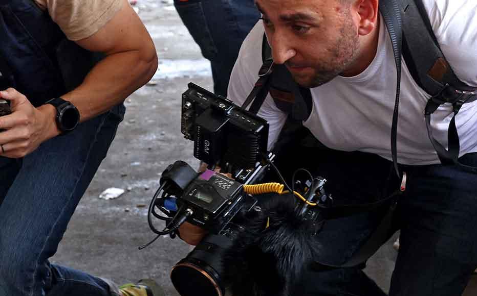 Journalists rush for cover inside a hospital in Jenin in the occupied West Bank on June 19, 2023 amid an Israeli army raid. Israeli forces in the occupied West Bank killed three Palestinians, in a raid that saw seven Israeli security personnel wounded and rare helicopter fire as the army said it pursued "wanted suspects".