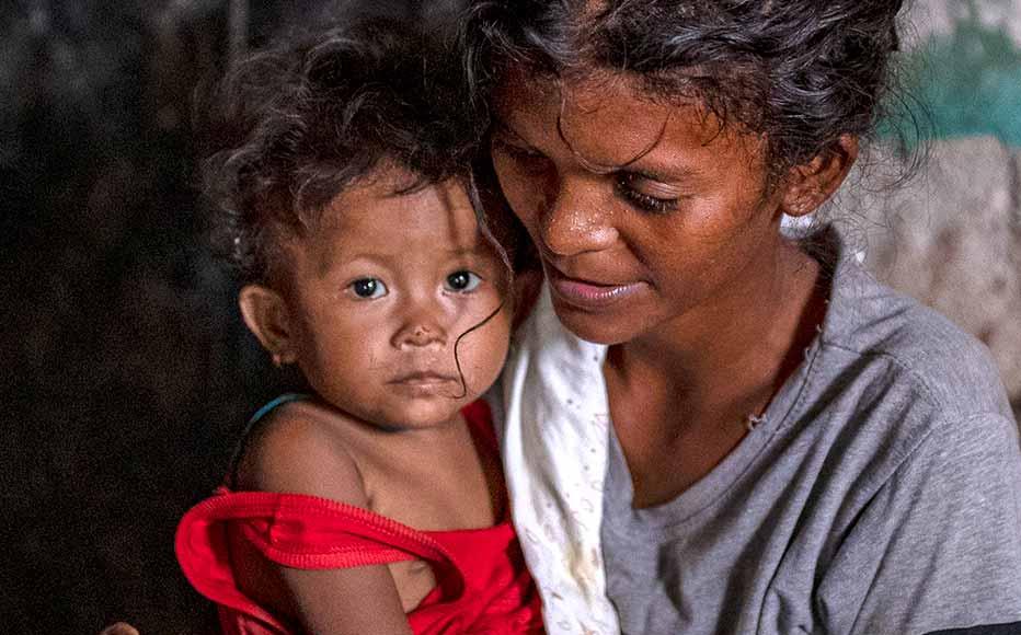 A woman holds her child in the remote village of Burog, in Bamban, Tarlac province, Philippines.