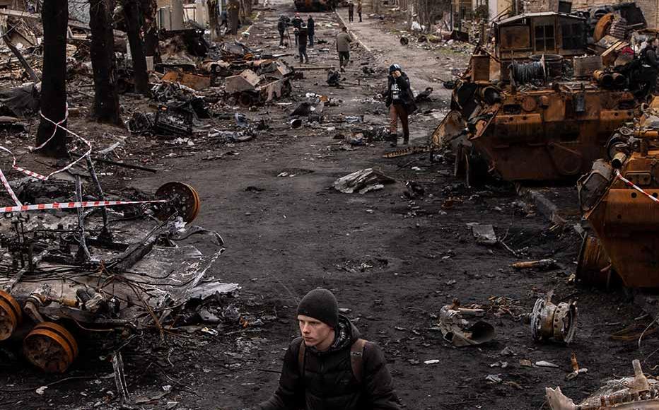 A man pushes his bike through debris and destroyed Russian military vehicles on a street on April 06, 2022 in Bucha, Ukraine. The Ukrainian government has accused Russian forces of committing a "deliberate massacre" as they occupied and eventually retreated from Bucha, 25km northwest of Kyiv. Hundreds of bodies have been found in the days since Ukrainian forces regained control of the town. A man pushes his bike through debris and destroyed Russian military vehicles on a street on April 06, 2022 in Bucha, Ukraine. The Ukrainian government has accused Russian forces of committing a "deliberate massacre" as they occupied and eventually retreated from Bucha, 25km northwest of Kyiv. Hundreds of bodies have been found in the days since Ukrainian forces regained control of the town.
