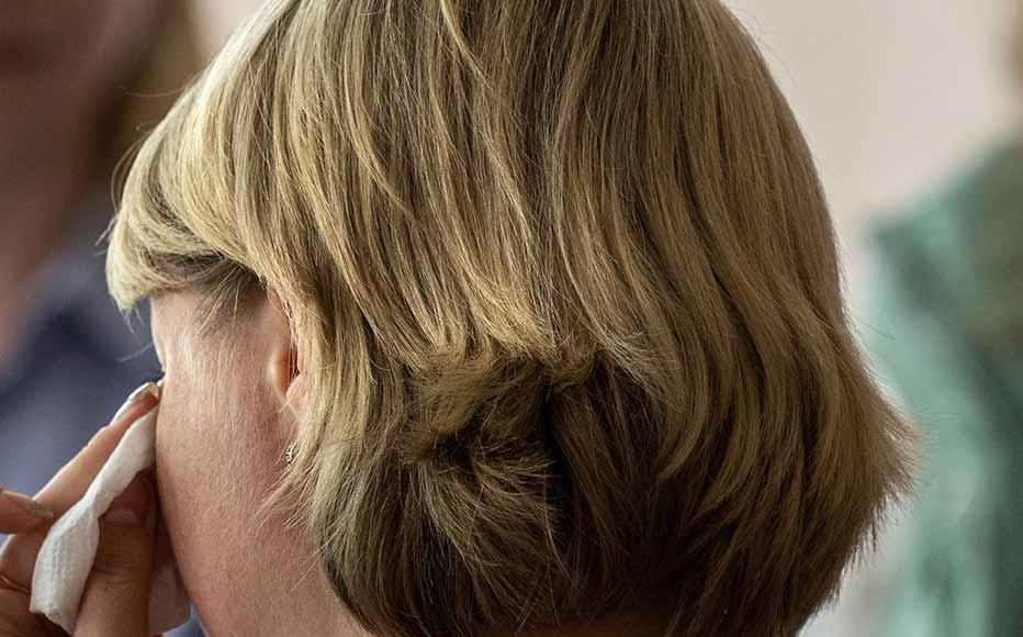 A woman displaced by war wipes tears during a counselling session as psychologists listen on May 03, 2022 in Kryvyi Rih, Ukraine. A woman displaced by war wipes tears during a counselling session as psychologists listen on May 03, 2022 in Kryvyi Rih, Ukraine.