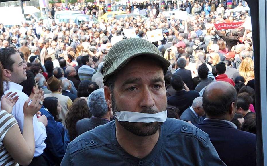 A Tunisian journalist holds a TV frame on April 25, 2012 during a sit-in outside the municipal theatre in Tunis to protesting silencing Tunisian Television journalists. A sit-in outside the municipal theatre in Tunis protesting silencing of TV journalists on April 25, 2012.