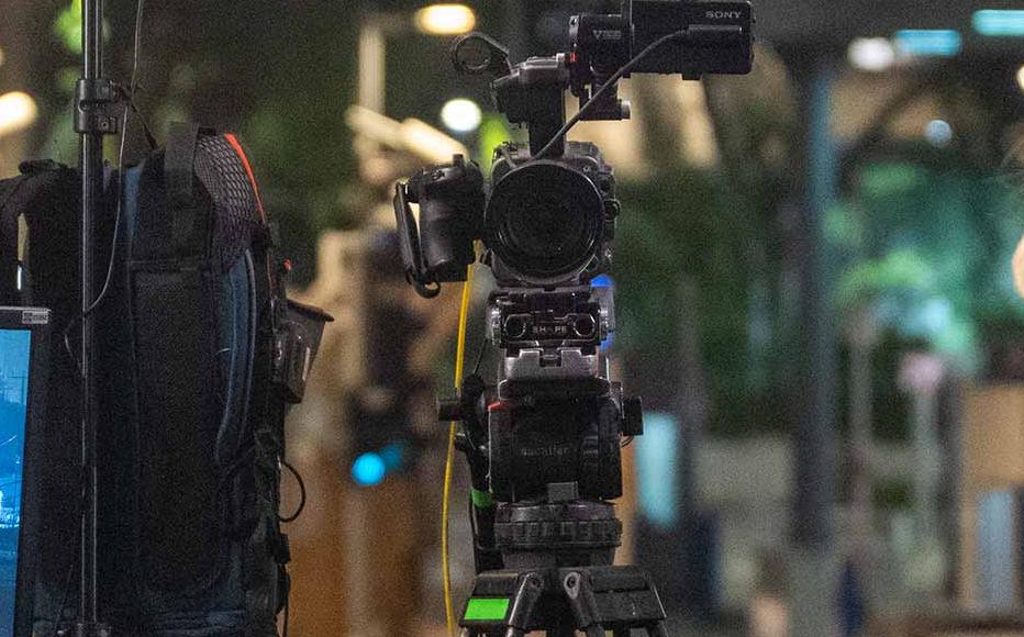 A news anchor waits for a broadcast as another 13 Israeli hostages are released from Gaza and brought back to Israel, during the third day of the temporary truce, outside The Museum of Modern Art known as the 'The Hostages and Missing Square' on November 25, 2023 in Tel Aviv, Israel.