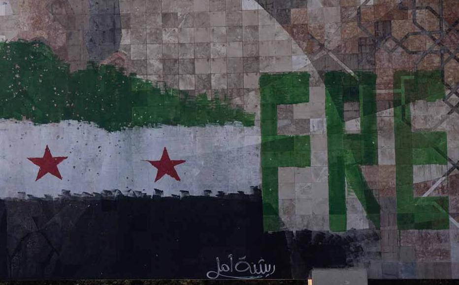 A defaced mural of Hafez al-Assad, father of former Syrian President Bashar al-Assad is seen on a highway on the outskirts of Damascus on December 17, 2024.