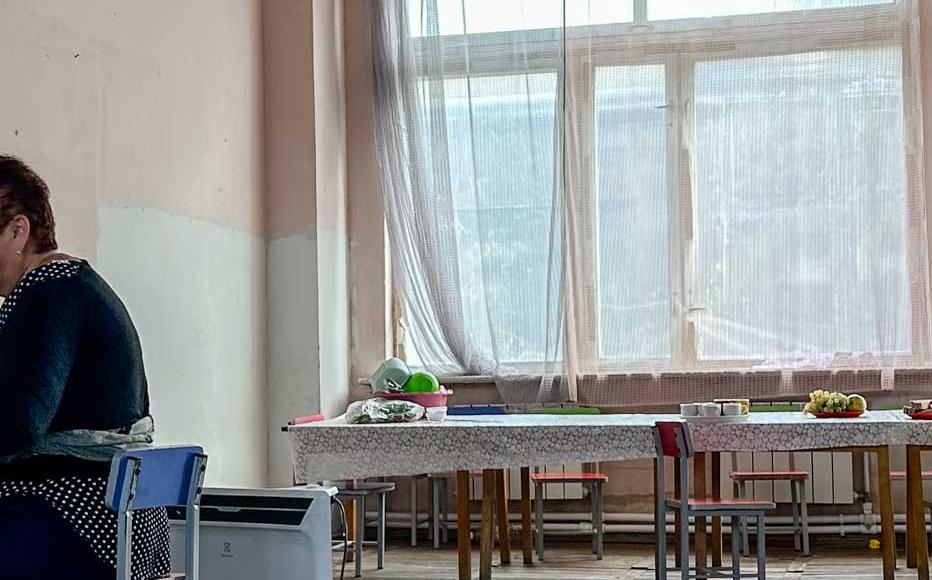 Madlena Ghahiryan irons clothes in one of the rooms of the kindergarten that has been turned into a living room. The 62-year-old nurse from the village of Khramort shares a room with 17 members of her family.