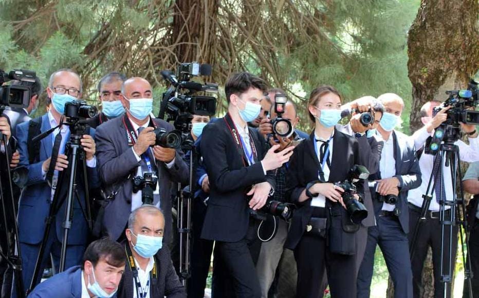 Tajik journalists near Kokhi Somon, the presidential residence, in Dushanbe in July 2021. Journalists and rights groups say that the space for independent media in Tajikistan is shrinking as criminal cases against reporters are on the rise, fostering self-censorship and democracy backsliding.