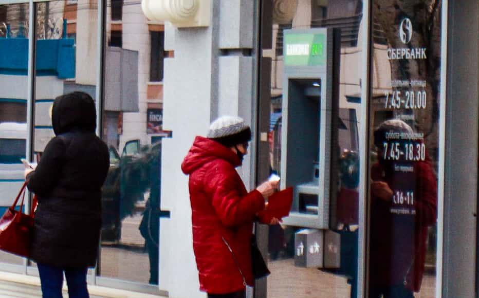 People queue at the cash machine of one of the branches of the Russian Sberbank bank in Tiraspol.