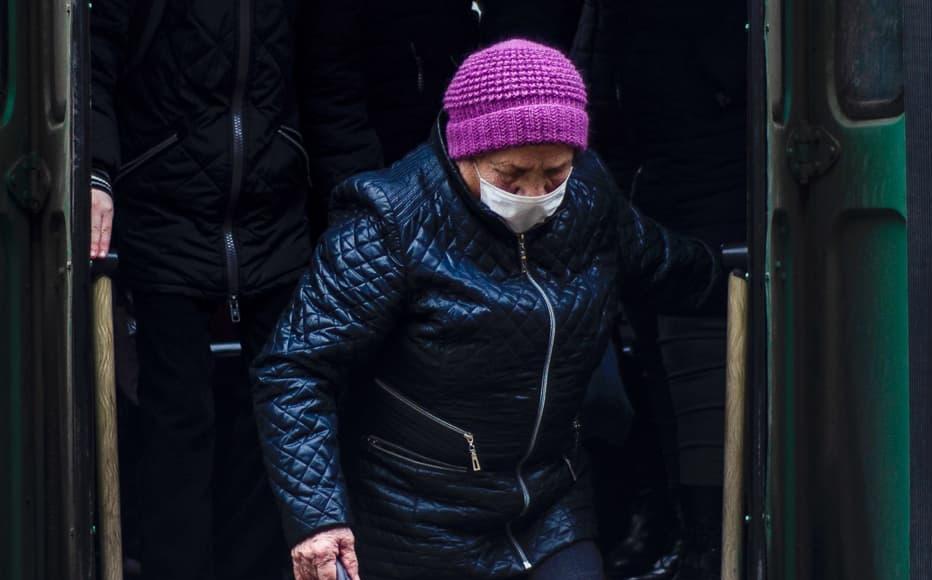 An elderly woman wears a mask on a bus in Tiraspol.