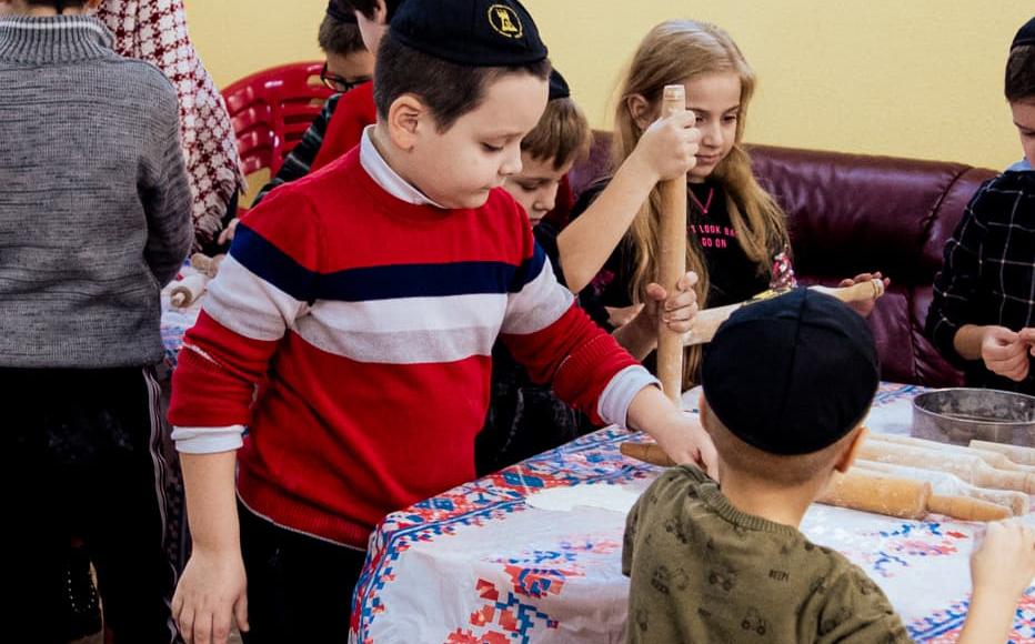 Children prepare the dough that will be used to cook krustyky, traditional Ukrainian fried biscuits, at Odesa’s main Jewish community centre, Mygdal Jewish Centre.