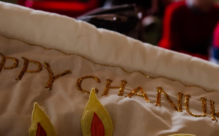 “Happy Chanukah” and a menorah stitched on cloth during a children’s gathering at the Mygdal Jewish Centre. “Happy Chanukah” and a menorah stitched on cloth during a children’s gathering at the Mygdal Jewish Centre.