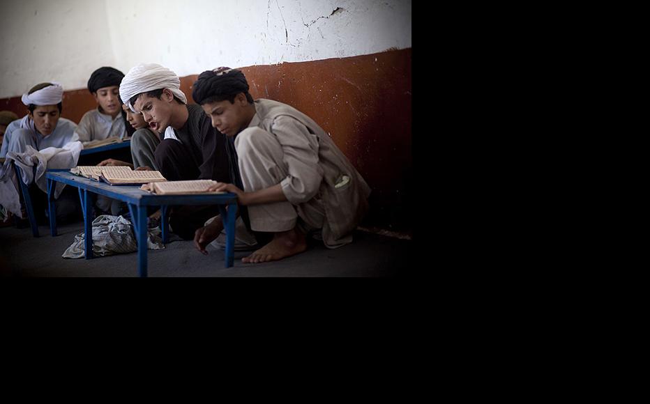 Afghan boys study Koran in a religious school. (Photo: Majid Saeedi/Getty Images)