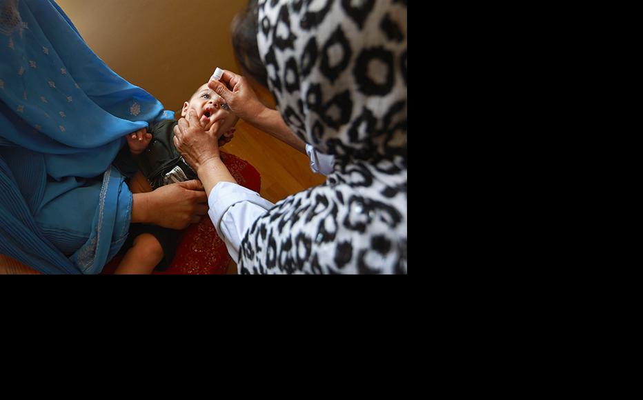 An Afghan child receives a polio vaccine at a clinic in Farza. (Photo: John Moore/Getty Images)