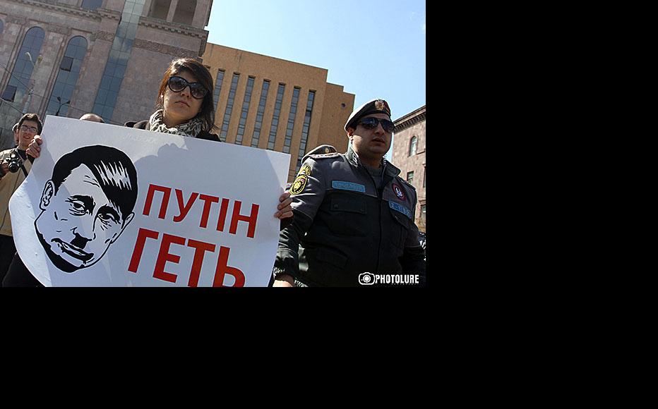 A protest holds a banner saying “Putin Get Out” during a demonstration outside the Russian embassy in Yerevan, March 5. (Photo: Photolure agency)