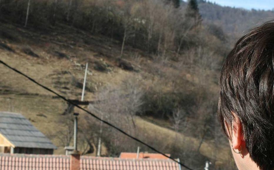 A woman raped by Croat soldiers looks at the house in which she was detained and abused in October 1993.