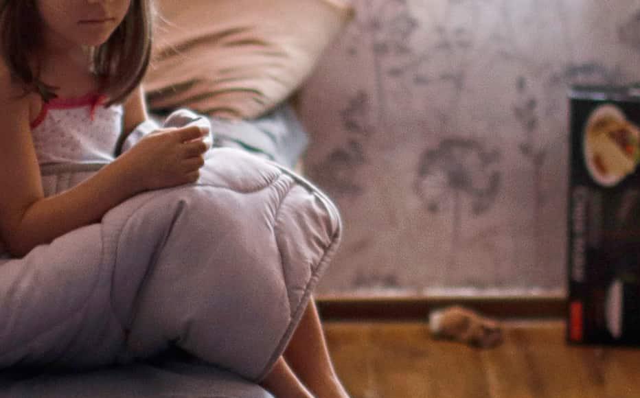 Six-year-old Elene sits on the bed of in her aunt’s 14 sq metre room. 