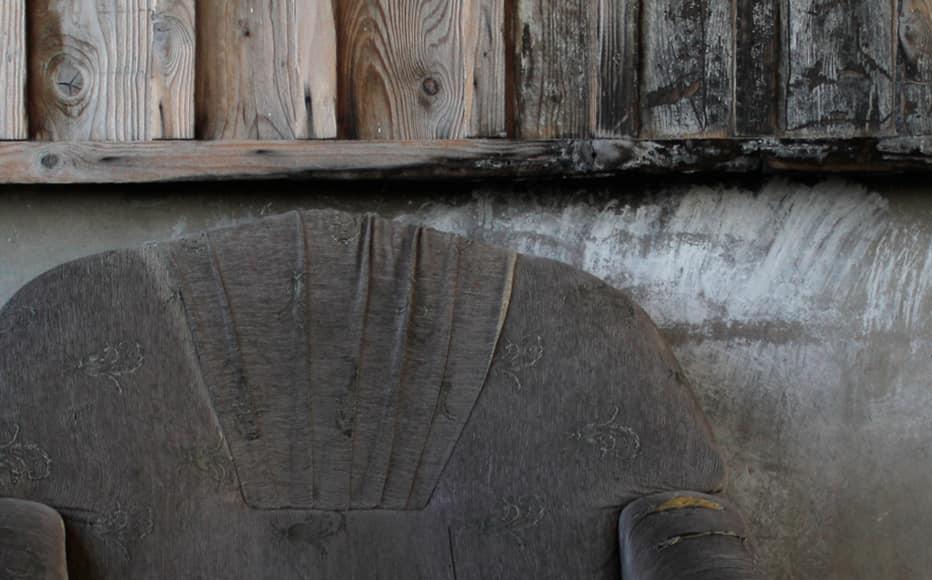 An old couch and broken watch in the hall in one of the two buildings of the Kartli complex. An old couch and broken watch in the hall in one of the two buildings of the Kartli complex.