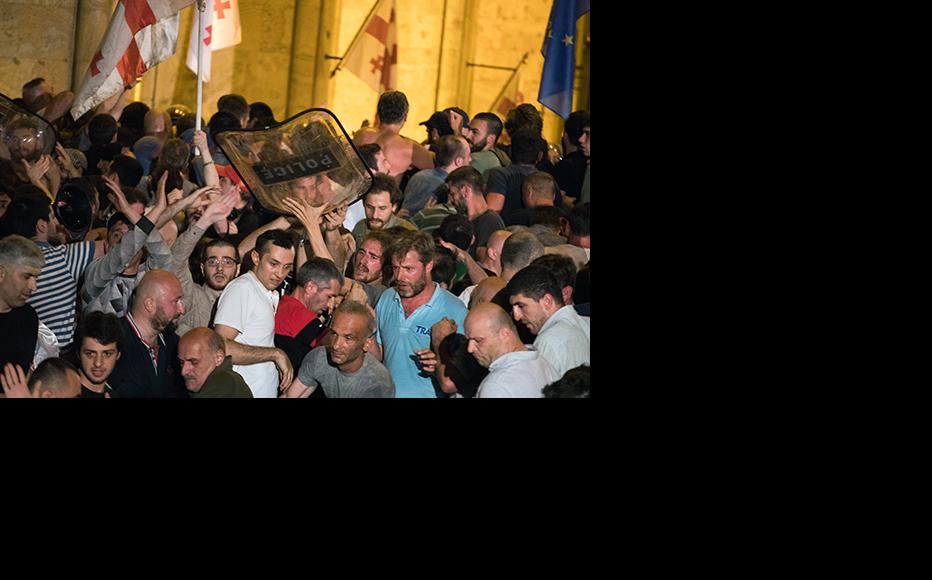Protestors take a riot shield from police. (Photo: Guram Muradov, Civil.Ge)