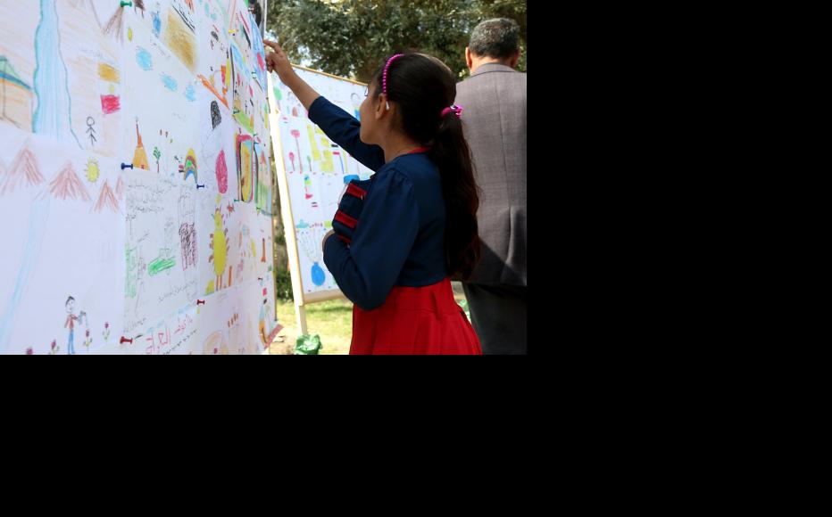 A child visiting the exhibition. (Photo: IWPR)