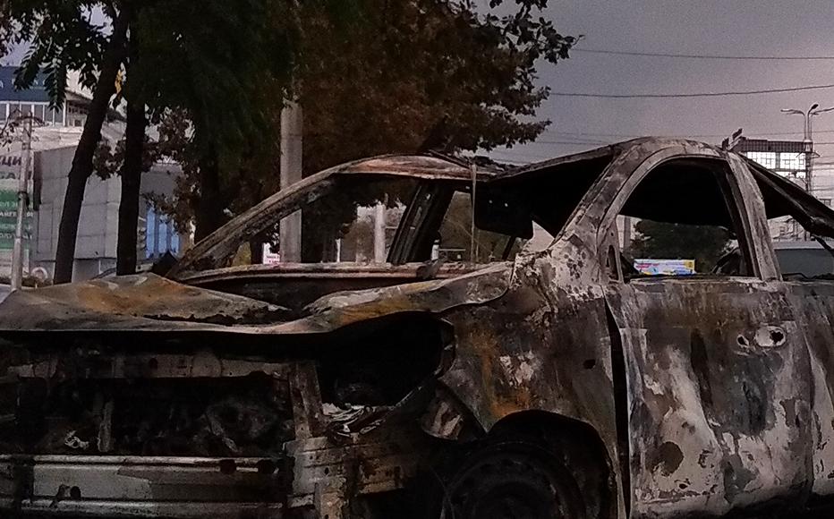 A burnt-out car in the centre of Bishkek.