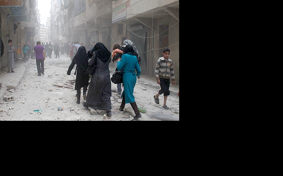 Women evacuating their houses after an airstrike on the Ansari neighbourhood in Aleppo. (Photo: Baraa al-Halabi)