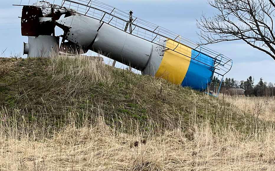 A water tower decnrated in the colours of the national flag lies destroyed in Zirka.