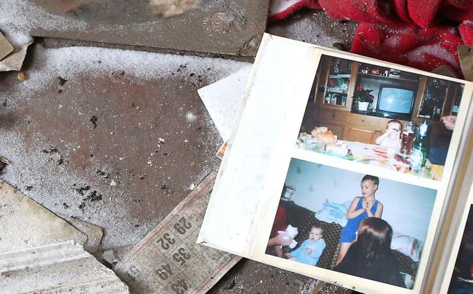 A family photo album lies abandoned in an empty apartment building in Pisky, Donetsk region (January 25, 2022)