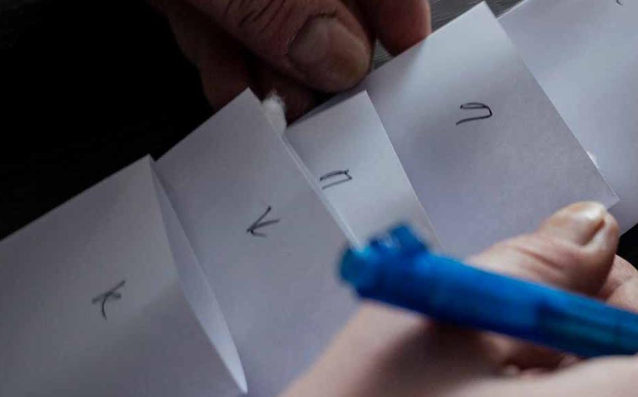 Prosecutor Ivan Likhovyn sorts Viktor Sytnyk’s DNA samples. Cotton swabs are rubbed inside his cheek, packed in an envelope and sent for forensic analysis. Prosecutor Ivan Likhovyn sorts Viktor Sytnyk’s DNA samples. Cotton swabs are rubbed inside his cheek, packed in an envelope and sent for forensic analysis.