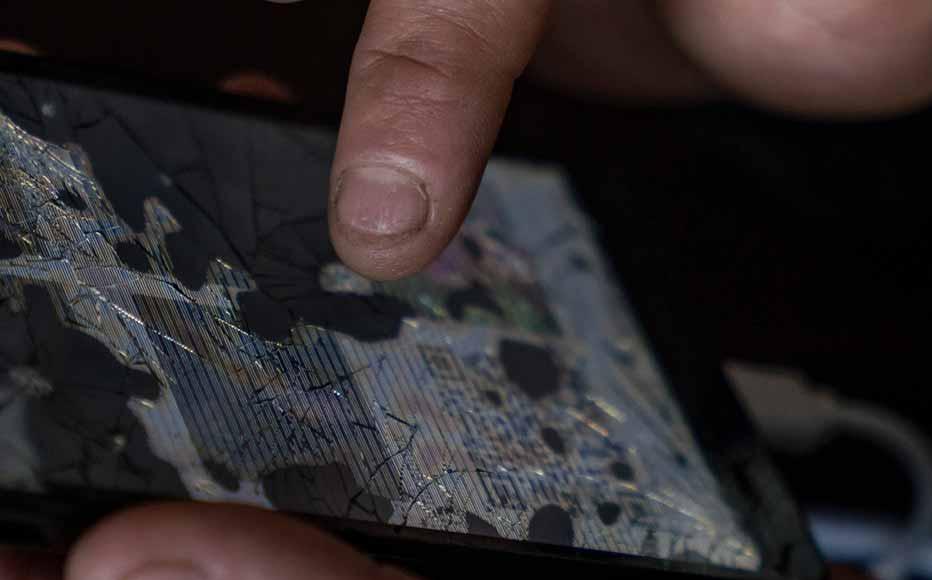 A woman tries to connect a broken phone to a prosecutor's computer to show a copy of her dead mother's passport.