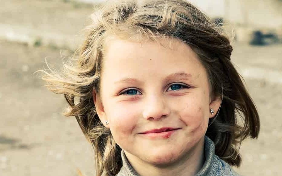 Eva plays with her kitten near the shelter where she lives with her mother and brother in the city of Rubizhne, about 117 kilometres north of Luhansk.