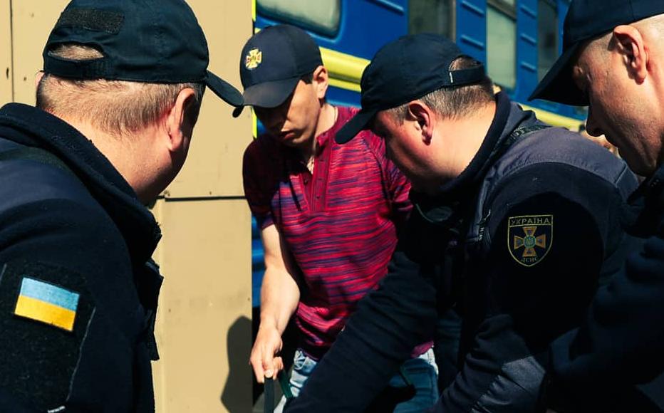 Employees of Ukraine’s state emergency situations service help a disabled person during the evacuation of civilians at the railway station in the city of Pokrovsk, in Donetsk region.