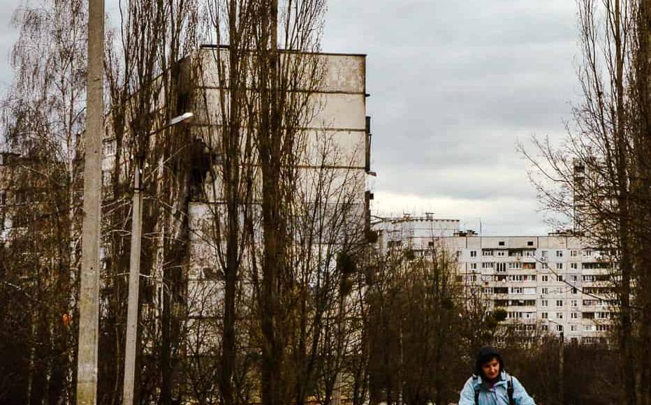 A woman rides her bicycle trough destroyed houses and deserted streets in north Saltivka in early April when the district suffered some of the most intense shelling. (April 2022)