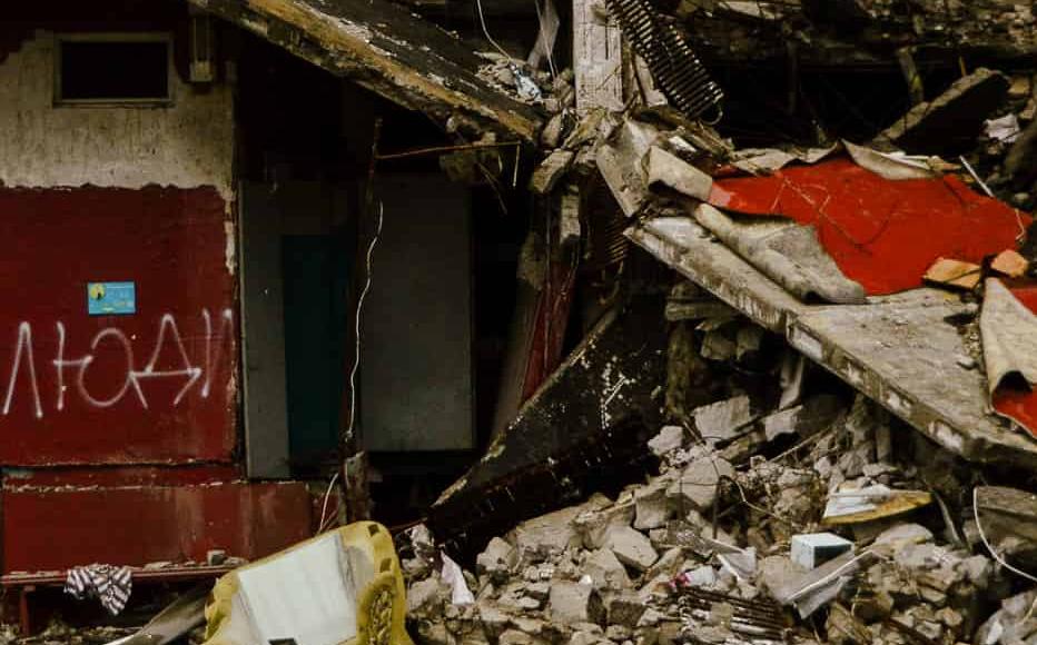 A destroyed house with graffiti reading "Люди" – People. (April 2022)