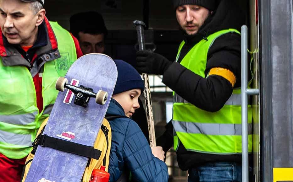 Volunteers with yellow ribbons and vests help people to board the evacuation train, making sure that families are not separated. Upon their arrival at the border, refugees can go to an emergency shelter or continue to other destinations across Poland and beyond.