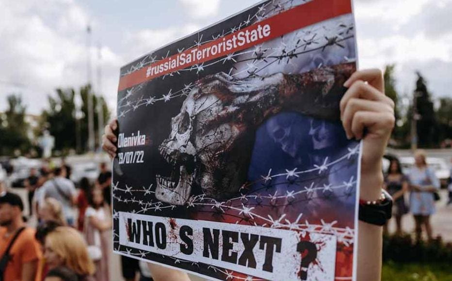 Olesia Nikolaienko holds a sign "Who's Next?" during a street protest in Zaporizhia on August 3 where hundreds of people called for accountability for Olenivka. An explosion in the prison facility in the eastern town killed at least 53 Ukrainian prisoners of war on July 29.