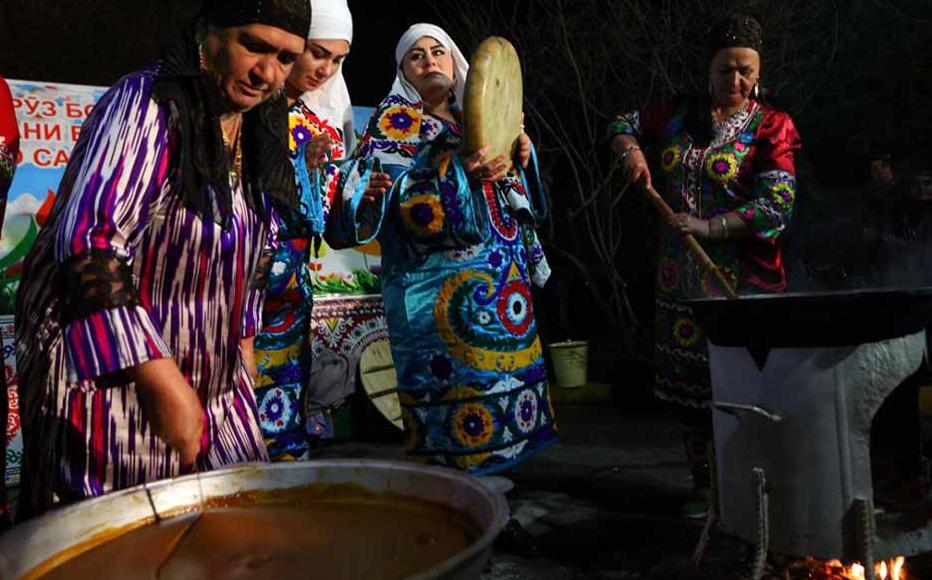 Women sell plates of sumalak at a Navruz fair in Dushanbe.