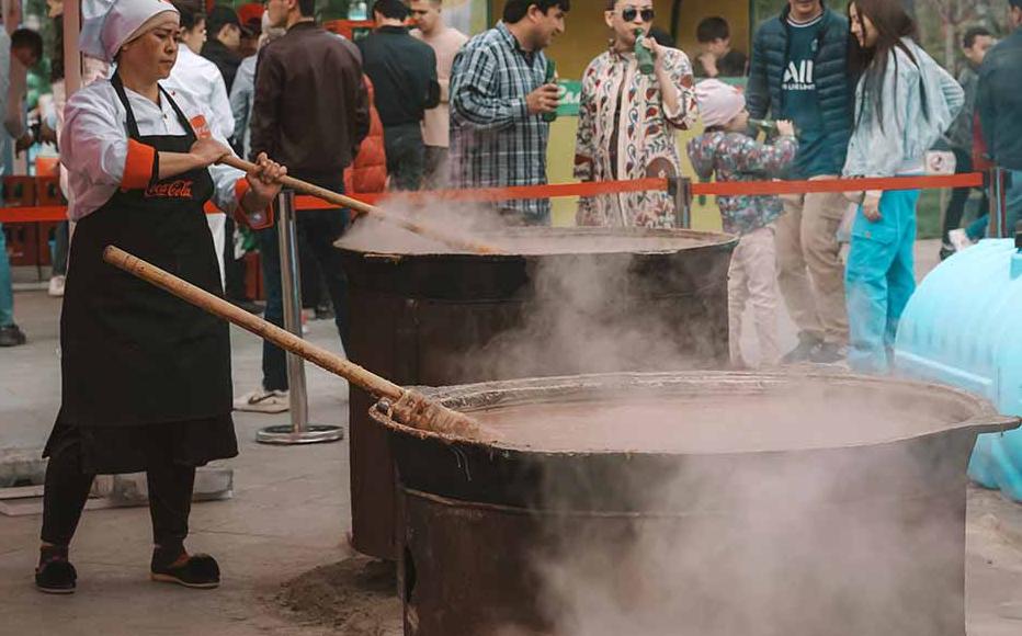 Traditionally cooked only by women, sumalak’s origins are shrouded in legend. According to one Uzbek story, a poor woman, needing to feed her four children, put river pebbles and a bunch of grass in her biggest cauldron and cooked it for a long time so that her kids would fall asleep without asking for food. She also fell asleep and when she woke up found the cauldron full of a brown, sweet and nourishing paste. She thought that angels, witnessing her plight, decided to help her. She fed her children and sh