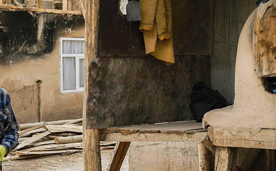 Residents work on the roof of an old house, near one of the local tandoor bread ovens. In the close-knit community mutual support is important: residents say they all know each other “up to the seventh generation”.