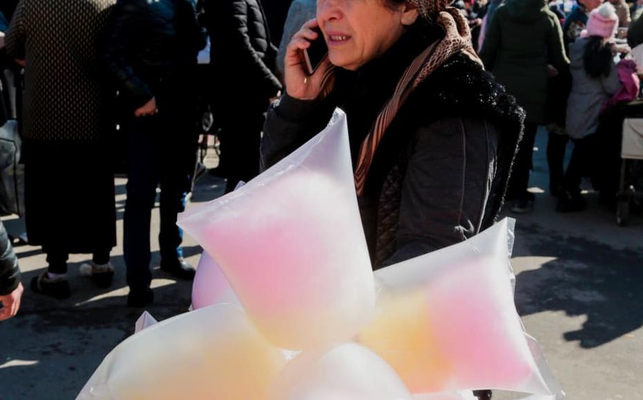 Malika sells candy floss in the busy Chorsu market in Tashkent. She earns about 40,000 soms (four dollars) a day. Malika sells candy floss in the busy Chorsu market in Tashkent. She earns about 40,000 soms (four dollars) a day.