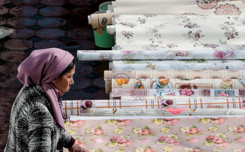 Nasiba sells oilcloth in a homeware shop in Chorsu. Nasiba sells oilcloth in a homeware shop in Chorsu.