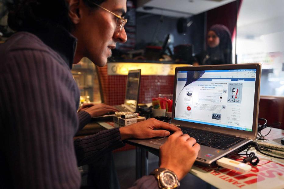 A man looks at a laptop computer displaying Facebook in a cafe on January 27, 2011 as anti government protesters take to the streets in Cairo, Egypt.