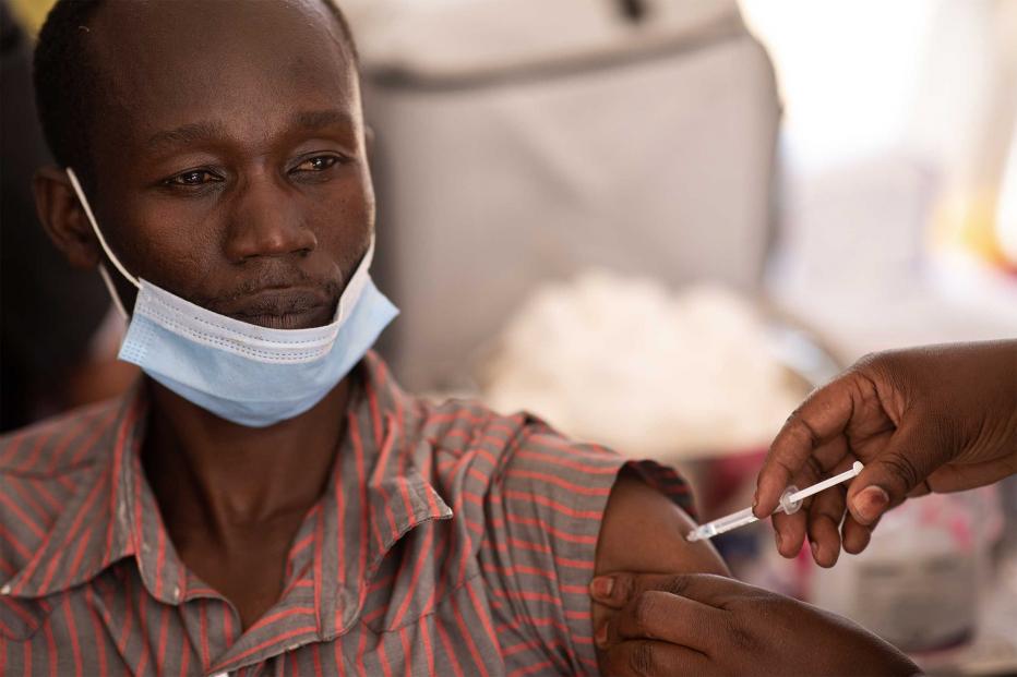 A healthcare professional is vaccinated against Covid-19 on March 10, 2021 in Kampala, Uganda.