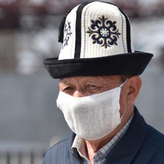 An elderly man in a Kyrgyz national hat wearing a face mask, amid concerns over the spread of coronavirus. Bishkek March 27, 2020.