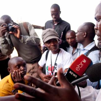 A bystander is interviewed by journalists in Nairobi, Kenya.