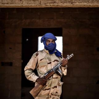 A militiaman poses with his weapon at an informal demobilization camp in Sevare, Mali, on July 6, 2019. The camp is run by a businessman with the goal of shifting young Fulani men away from jihadism.