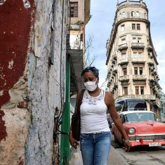 A woman wearing a face mask walks in Havana on September 14, 2020.