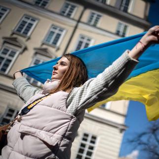 A woman waves the Ukrainian national flag in support of the residents and defenders of Mariupol on March 19, 2022 in Lviv, Ukraine.
