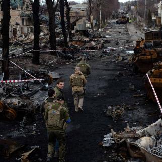 Ukrainian servicemen walk on the destroyed street on April 4, 2022 in Bucha, Ukraine. The Ukrainian government has accused Russian forces of committing a "deliberate massacre" as they occupied and eventually retreated from Bucha, 25km northwest of Kyiv.