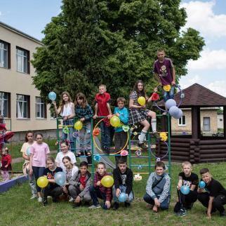 School students pose for a portrait with blue and yellow balloons in the colours of the Ukrainian national flag during Childrens Day activities on June 1, 2022 in Rusaniv, Ukraine.